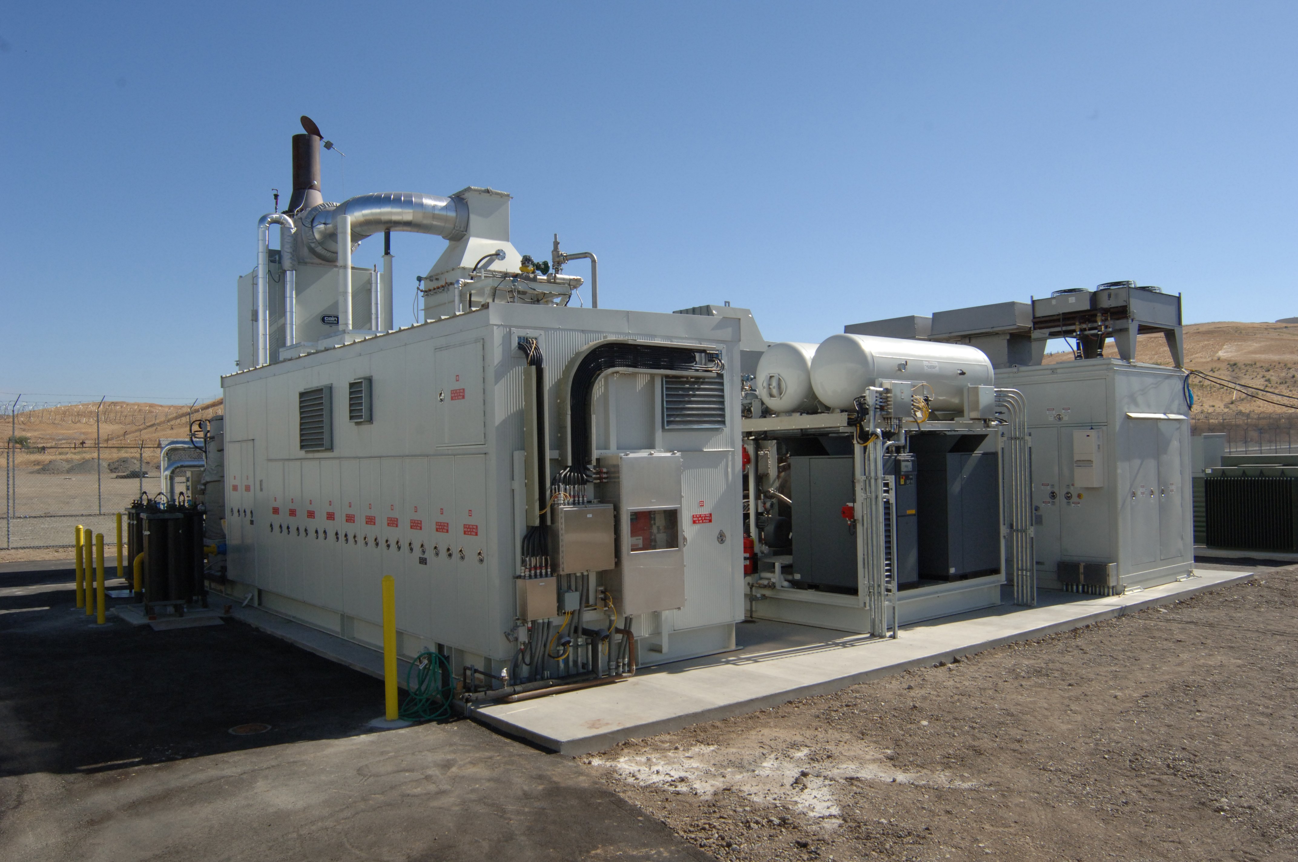 Fuel cell power generation units installed outdoors against a blue sky at the Alameda County Santa Rita Jail.