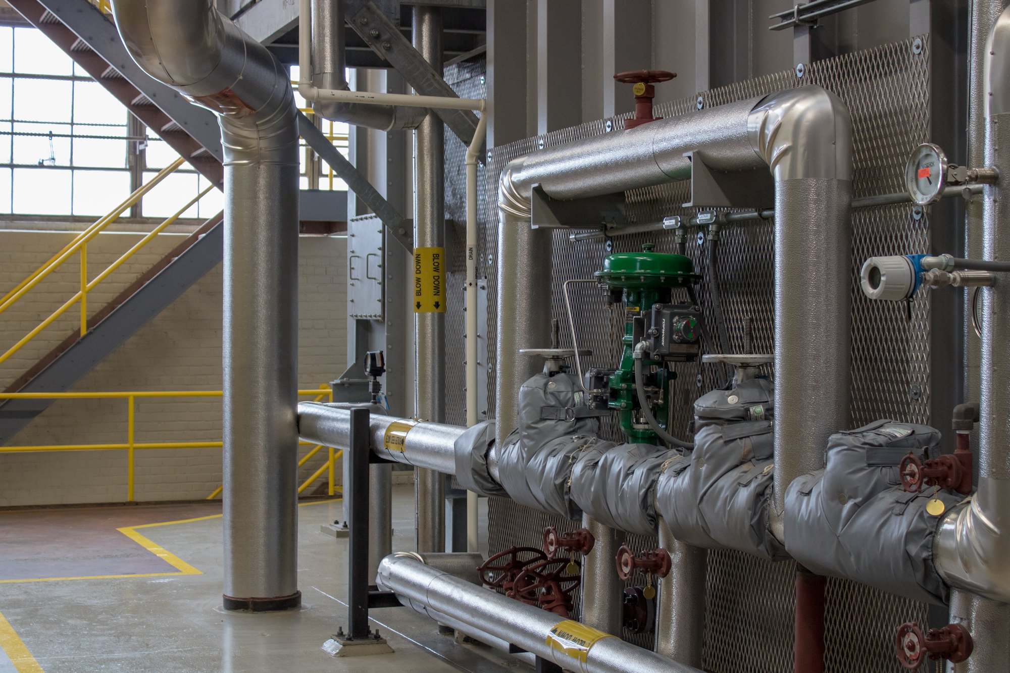 Mechanical room at Eastern Michigan University featuring upgraded piping, pumps, and energy infrastructure as part of a campus efficiency improvement project.