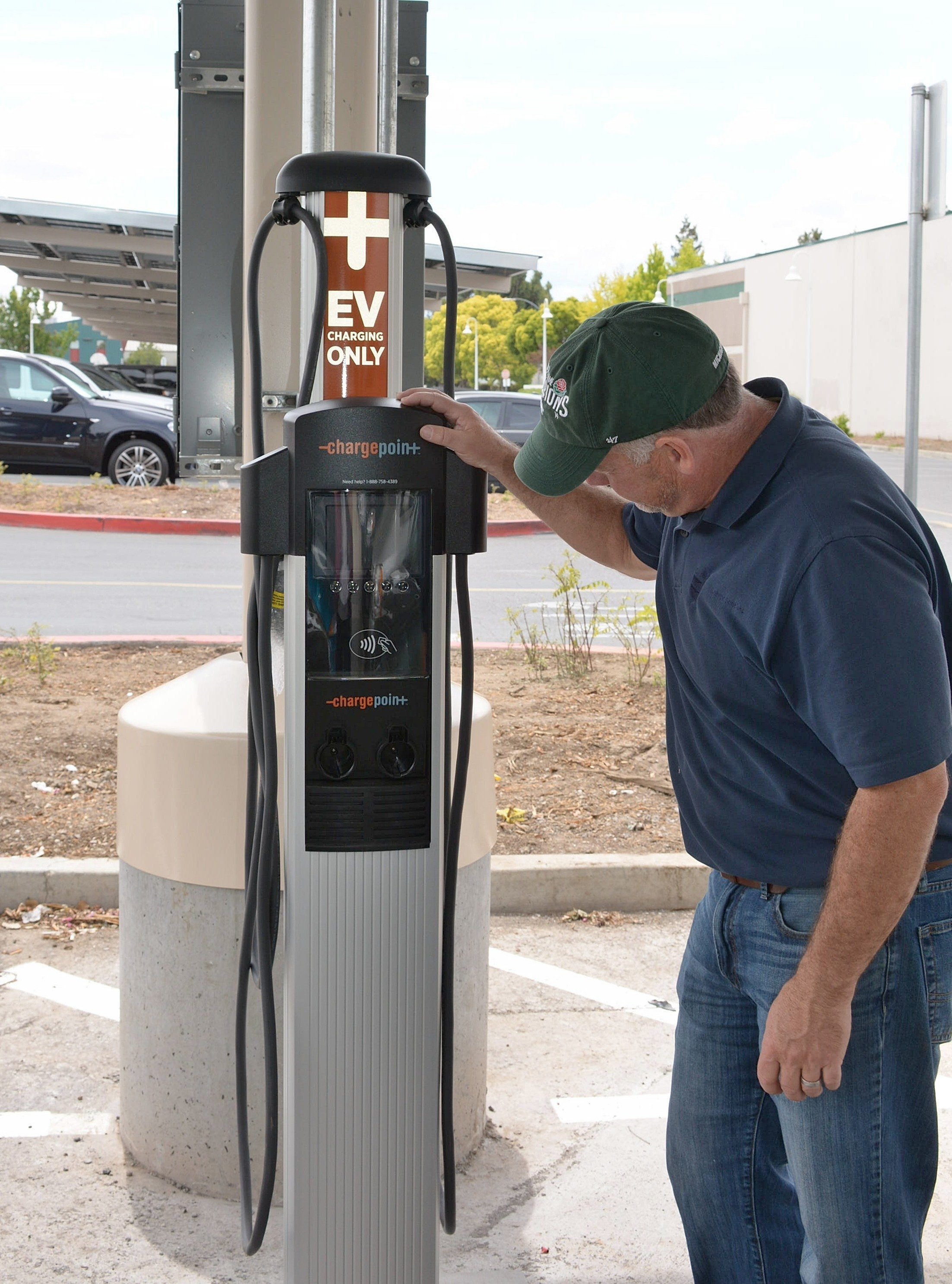 Electric vehicle charging station supporting fleet and employee charging at a school district facility.