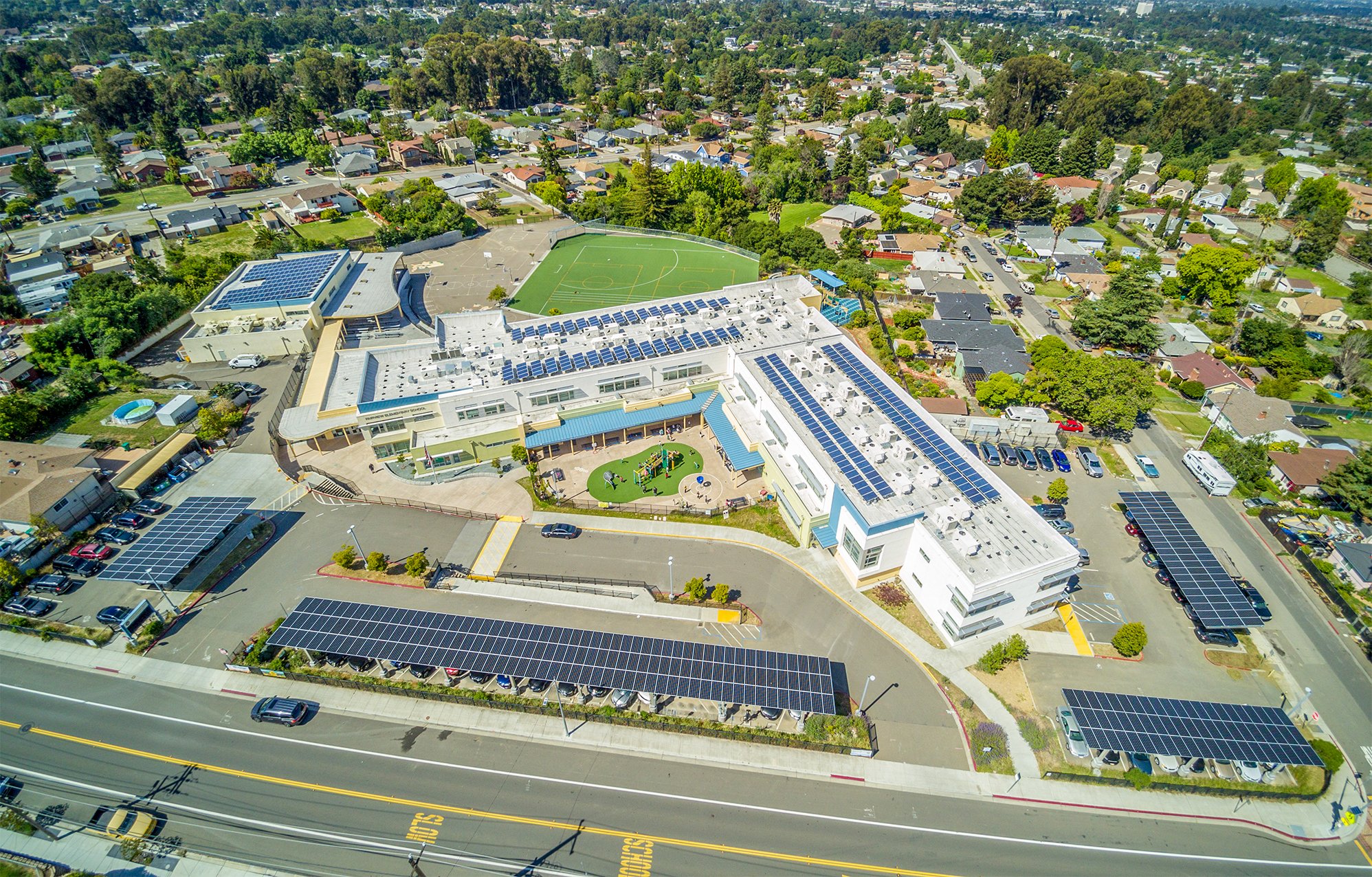 Aerial view of Hayward Unified School District’s Fairview campus featuring onsite solar energy infrastructure and parking lot solar canopies.