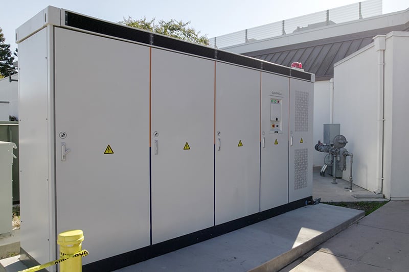 Microgrid electrical equipment cabinets with hazard labels installed outdoors at the City of Milpitas.