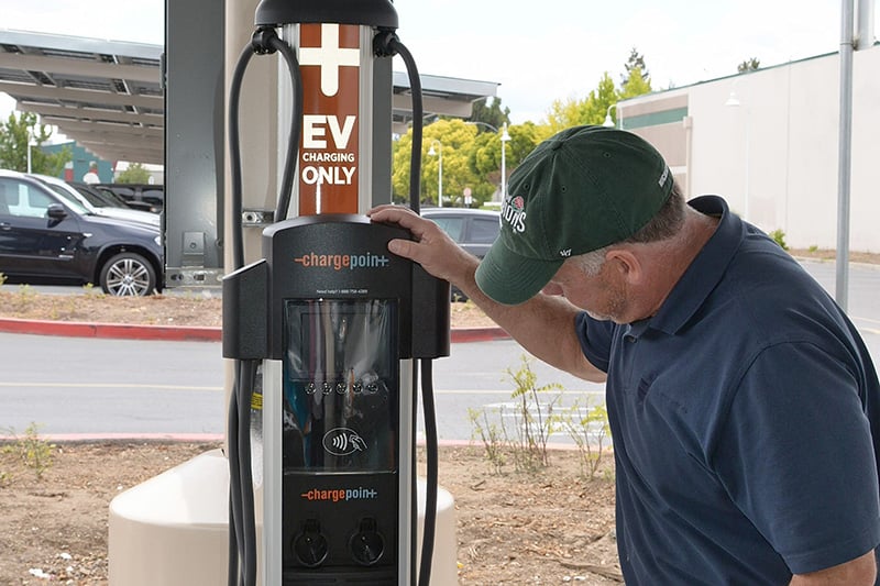 Electric vehicle charging station supporting fleet and employee charging at a school district facility.