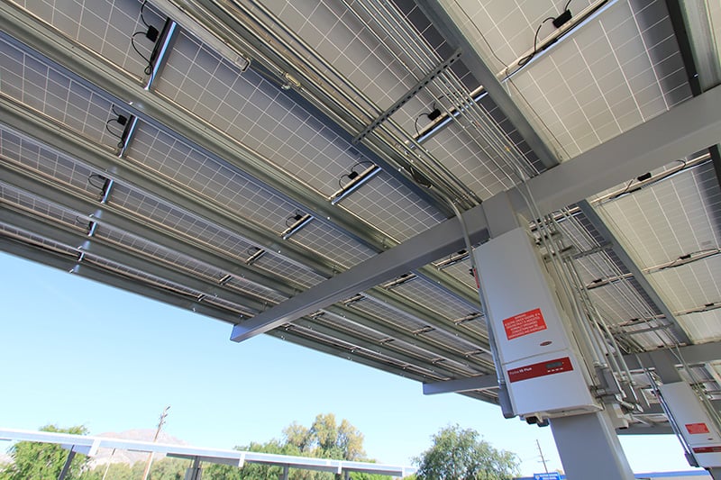 Solar canopy providing shaded parking while generating renewable electricity and supporting electric vehicle charging infrastructure.