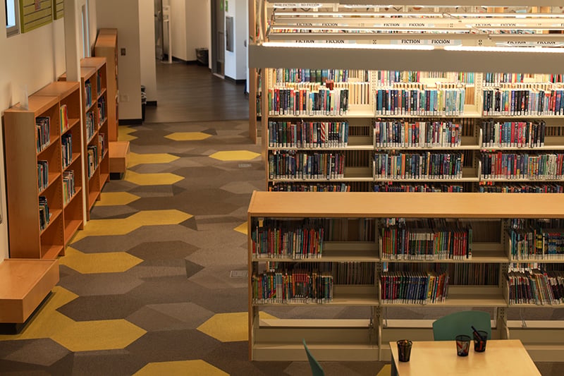 School library featuring STEM books donated as part of a community investment initiative.
