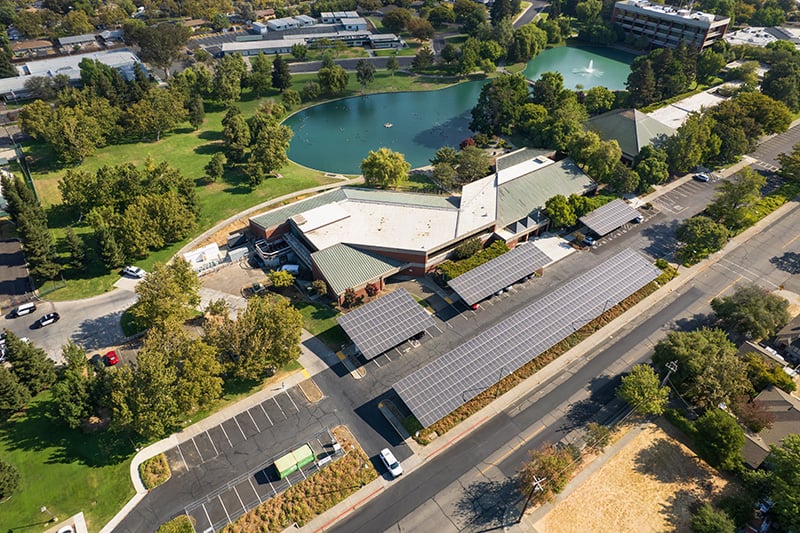 Aerial view of a Solano County library with onsite solar generation and microgrid system installed in the parking lot.