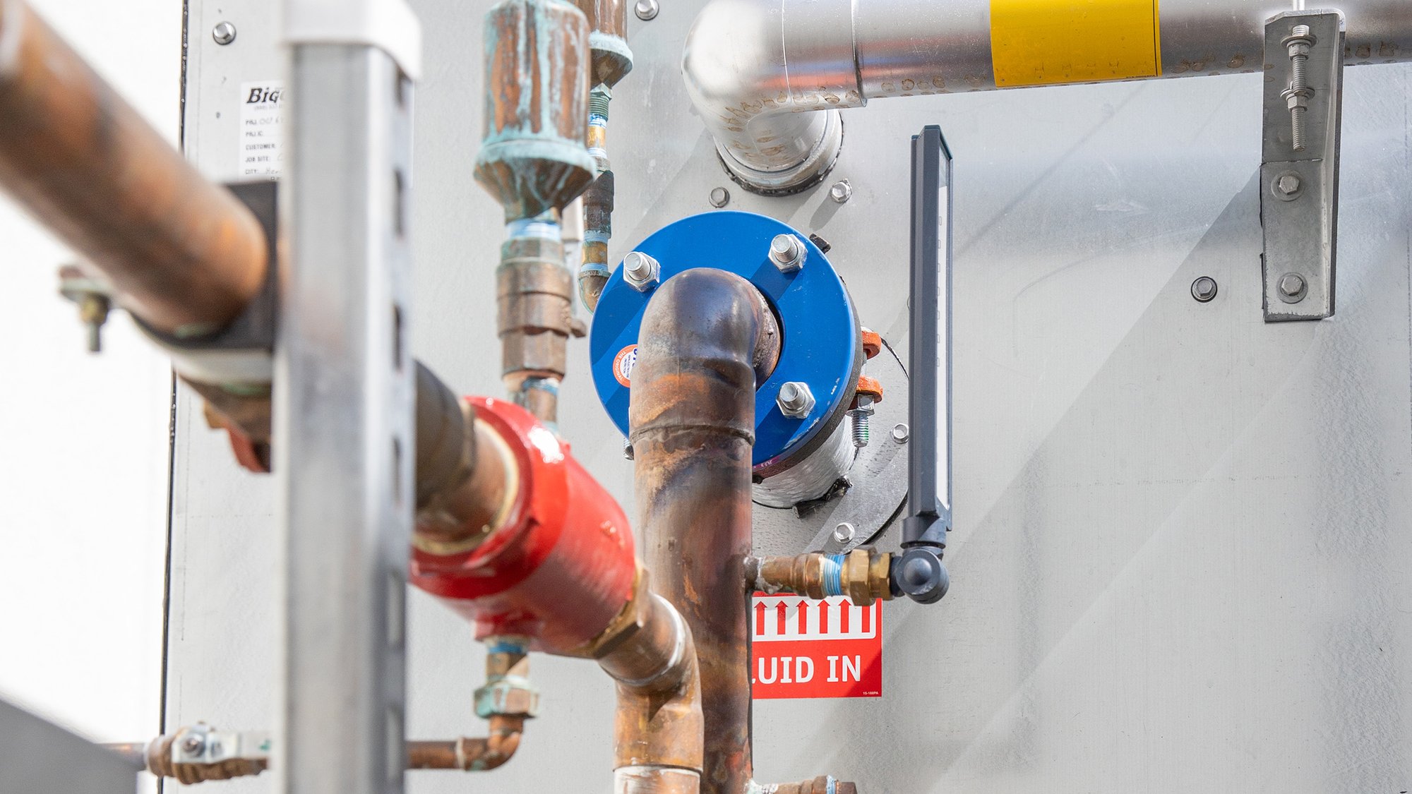 A mechanical room with upgraded pumps, piping, and valves.