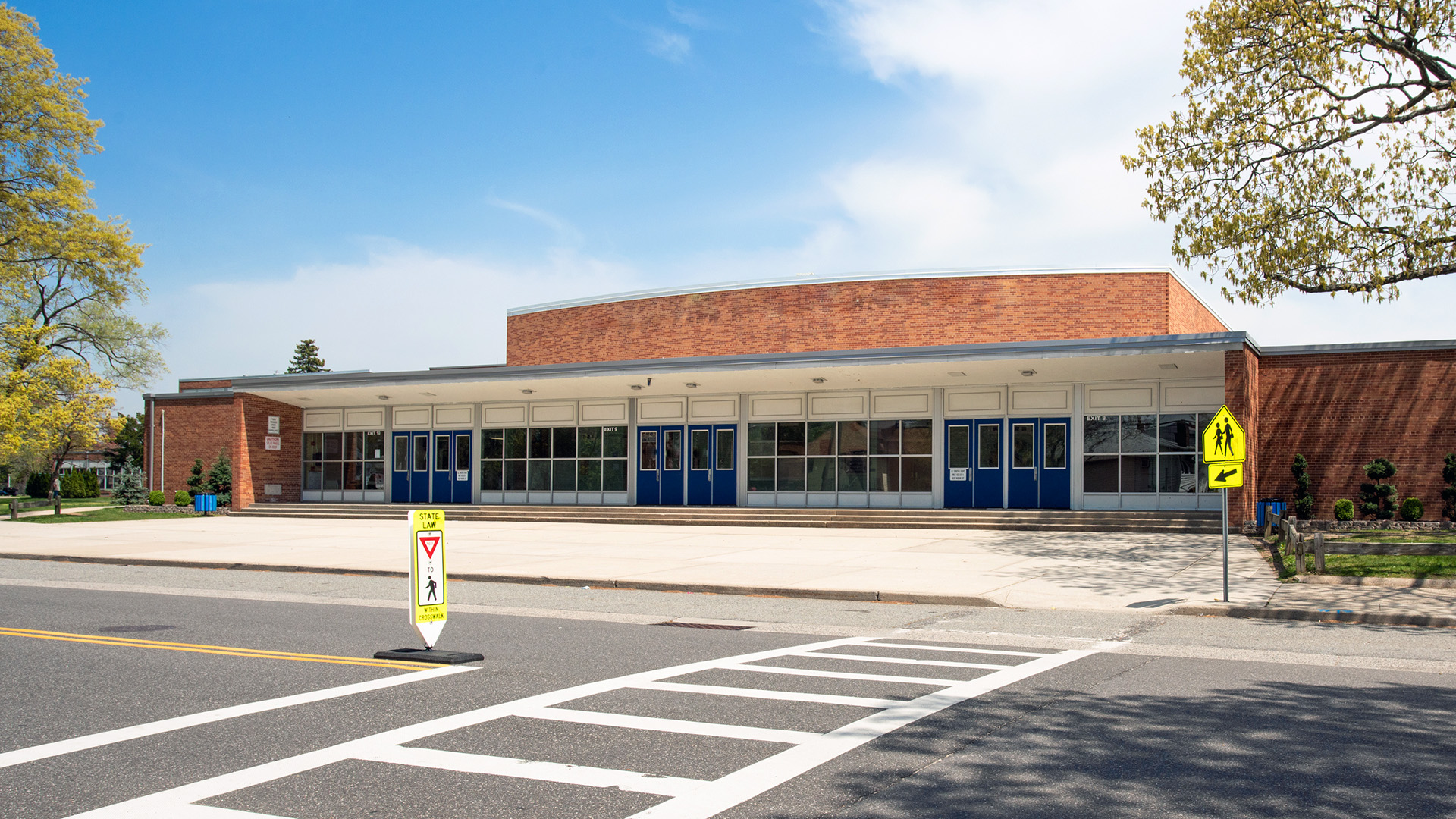 Modern school facility with upgraded pedestrian safety features and infrastructure improvements supporting education modernization.